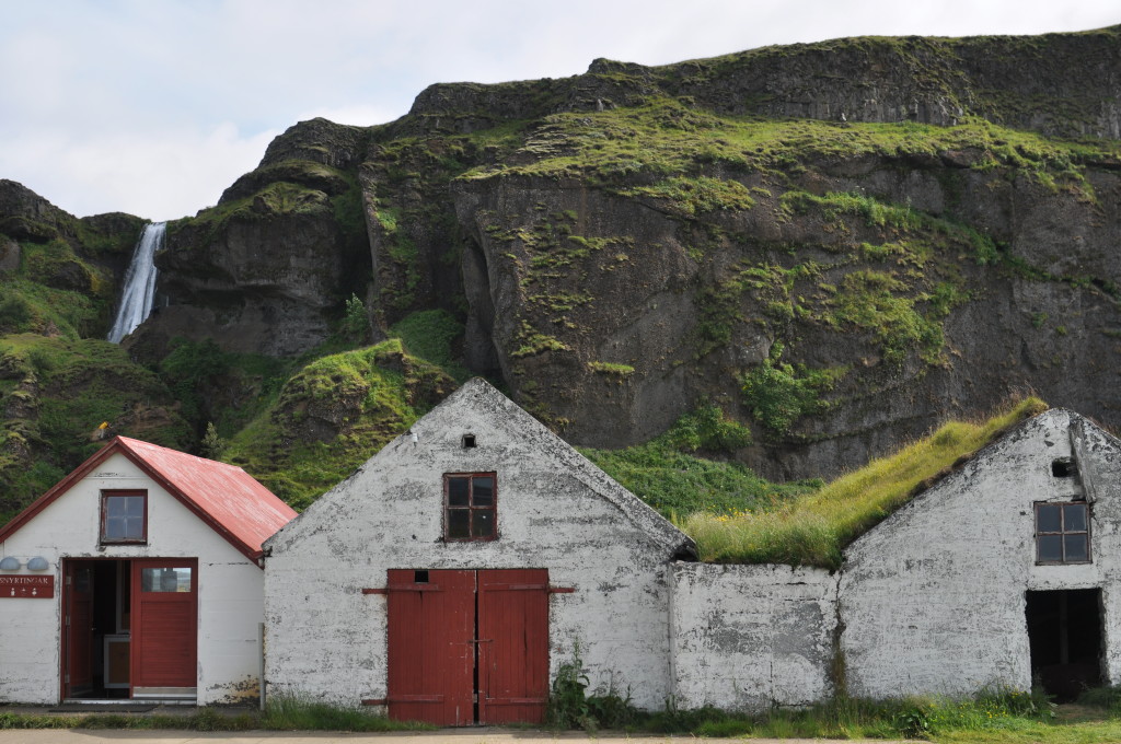 An abandoned farmstead sits at the bottom of one of the several falls near Seljalandsfoss.