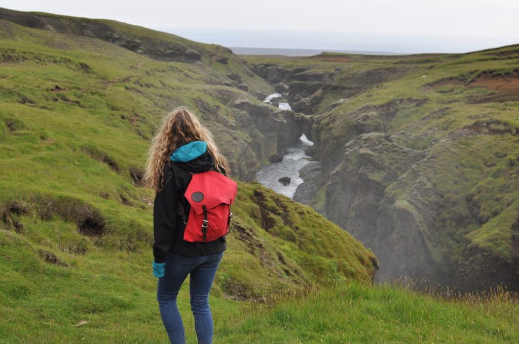 Here is Lily just strolling through magical fairy lands and the impossible home of the Huldufólk above Skógafoss.